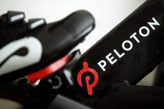 FILE - This Nov. 19, 2019 file photo shows the logo on a Peloton bike in San Francisco. Peloton's shares skidded in aftermarket trading Thursday, Aug. 26, 2021, after the exercise bike and treadmill company posted a loss for its most-recent quarter, showed slower revenue growth, and cut the price of its most-popular product.(AP Photo/Jeff Chiu, File)