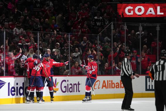 Washington Capitals right wing Tom Wilson (43) celebrates his goal with teammates during the second period of an NHL hockey game against the New York Rangers, Saturday, Feb. 25, 2023, in Washington. (AP Photo/Julio Cortez)