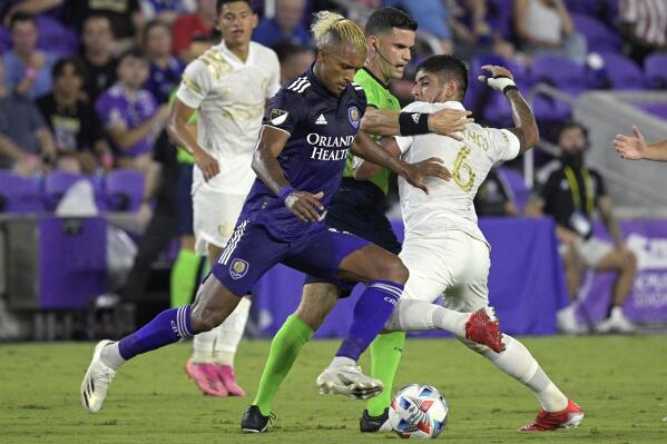Orlando City forward Nani, front, takes the ball as Atlanta United defender Alan Franco (6) is blocked by an official during the first half of an MLS soccer match Friday, July 30, 2021, in Orlando, Fla. (Phelan M. Ebenhack/Orlando Sentinel via AP)