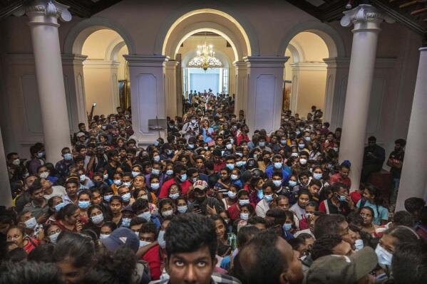 FILE - People gather inside President Gotabaya Rajapaksa's official residence for the second day after it was stormed in Colombo, Sri Lanka, July 11, 2022. (AP Photo/Rafiq Maqbool, File)