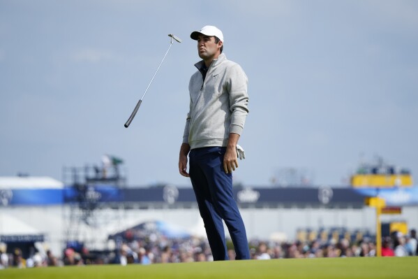 United States' Scottie Scheffler reacts after putting on the 6th green on the first day of the British Open Golf Championships at the Royal Liverpool Golf Club in Hoylake, England, Thursday, July 20, 2023. (AP Photo/=0065cd=)