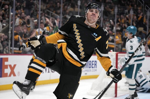 Pittsburgh Penguins' Evgeni Malkin (71) celebrates after his goal during the second period of an NHL hockey game against the San Jose Sharks in Pittsburgh, Thursday, March 14, 2024. (AP Photo/Gene J. Puskar)