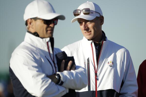 FILE - U.S. team captain Jim Furyk, right, stands alongside vice-captain Zach Johnson on the driving range at Le Golf National in Guyancourt, outside Paris, France, Tuesday, Sept. 25, 2018. Furyk has been named U.S. captain for the 2024 Presidents Cup at Royal Montreal. (AP Photo/Matt Dunham, File)