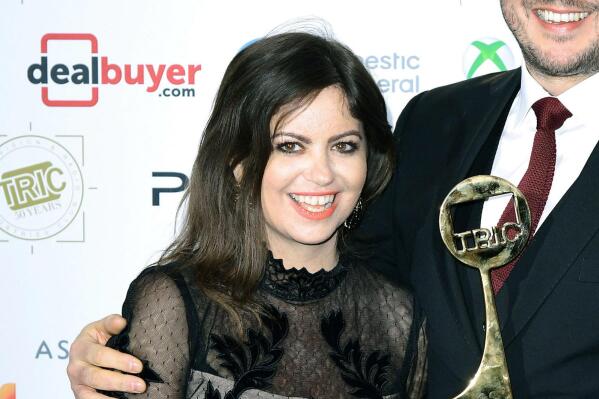FILE Cancer Campaigner Deborah James, left and Steve Bland pose for a photo with the award for Best Podcast for the show You, Me and the Big C at the TRIC Awards 2019 50th Birthday Celebration, at the Grosvenor House Hotel, London, March 12, 2019. James, a B ritish broadcaster who raised millions for cancer research and was recognized by Prince William for her work, has died. She was 40. James hosted a BBC podcast called “You, Me and The Big C"  in which she spoke in a no-nonsense approach about living with bowel cancer. (Ian West/PA via AP, File)