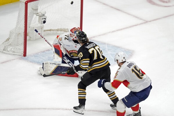 Boston Bruins' Jesper Boqvist (70) scores past Florida Panthers' Sergei Bobrovsky (72) ahead of Aleksander Barkov (16) during overtime in an NHL hockey game, Saturday, April 6, 2024, in Boston. (AP Photo/Michael Dwyer)