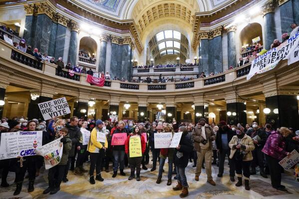 Protesters are seen in the Wisconsin Capitol Rotunda during a march supporting overturning Wisconsin's near total ban on abortion Sunday, Jan. 22, 2023, in Madison, Wis. (AP Photo/Morry Gash)