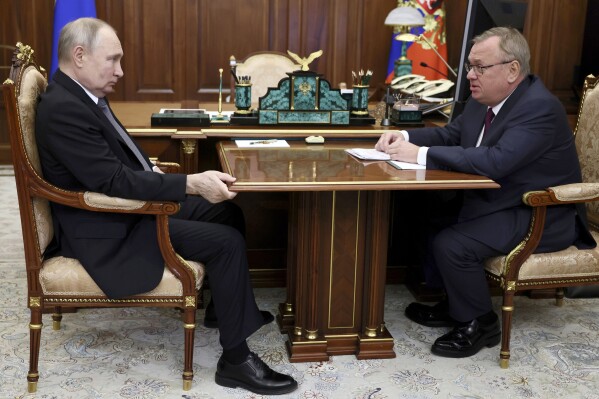 FILE - Russian President Vladimir Putin, left, listens to VTB Bank Chairman Andrei Kostin during their meeting in Moscow, Russia, July 11, 2023. The Justice Department announced Thursday, Feb. 22, 2024, a series of arrests and indictments against Russian businessmen and their facilitators in five separate federal cases meant to send a message to Russian President Vladimir Putin. Among those targeted are sanctioned Russian banker Kostin and two of his U.S.-based facilitators. (Alexander Kazakov, Sputnik, Kremlin Pool Photo via AP, File)