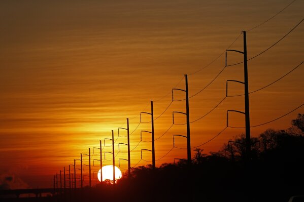 
              FILE - In this Jan. 31, 2018, file photo, the sun rises beyond power lines in St. Charles Parish, La. Homeland Security officials say that Russian hackers used conventional tools to trick victims into entering passwords in order to build out a sophisticated effort to gain access to control rooms of utilities in the U.S. The victims included hundreds of vendors that had links to nuclear plants and the electrical grid.  (AP Photo/Gerald Herbert, File)
            
