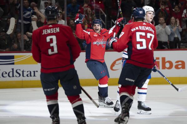 Washington Capitals left wing Conor Sheary (73) celebrates with defenseman Nick Jensen (3) and defenseman Trevor van Riemsdyk (57) after scoring a goal against the Montreal Canadiens during the second period of an NHL hockey game, Saturday, Oct. 15, 2022, in Washington. (AP Photo/Jess Rapfogel)