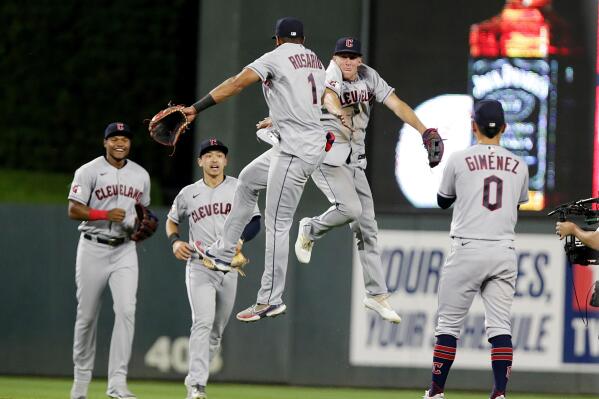 Cleveland Guardians' Amed Rosario (1) and Myles Straw jump between Oscar Gonzalez, left, Steven Kwan and Andres Gimenez (0) after the Guardians defeated the Minnesota Twins in a baseball game Wednesday, June 22, 2022, in Minneapolis. (AP Photo/Andy Clayton-King)