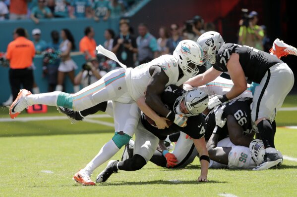 
              FILE - In this Sunday, Sept. 23, 2018, file photo, Miami Dolphins defensive end William Hayes (95) sacks Oakland Raiders quarterback Derek Carr (4) during the first half of an NFL fo...