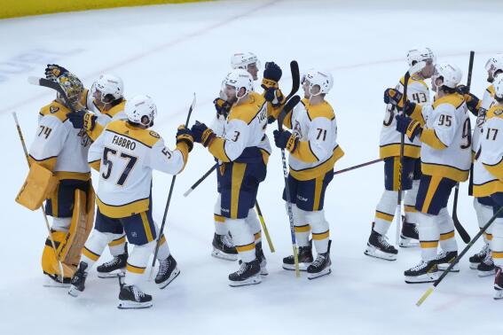 The Nashville Predators celebrate their win over the Chicago Blackhawks in an NHL hockey game Saturday, March 4, 2023, in Chicago. (AP Photo/Charles Rex Arbogast)