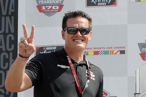 FILE - In this Saturday, June 5, 2021, file photo, car owner Matt Kaulig gestures in Victory Lane after A.J. Allmendinger won a NASCAR Xfinity Series auto race at Mid-Ohio Sports Car Course in Lexington, Ohio. JR Motorsports has had initial conversations about taking its team to NASCAR's top level, a step up to Cup that would be much smoother if it could get its hands on a charter.  Two charters went off the board earlier this month when Kaulig Racing purchased a pair from Spire Motorsports, a team that bought low and stockpiled when potential owners had little interest in NASCAR.  (AP Photo/Tom E. Puskar, File)