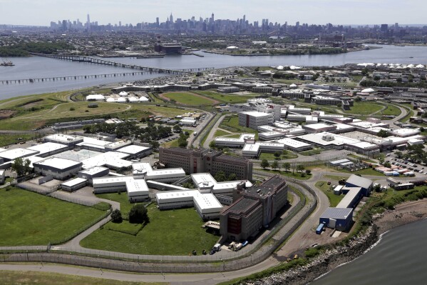 FILE - This aerial photo shows Rikers Island, New York's biggest lockup, June 20, 2014. Two former New York City jail guards won’t serve any prison time in connection with a teenage inmate’s suicide attempt in 2019. (AP Photo/Seth Wenig, File)