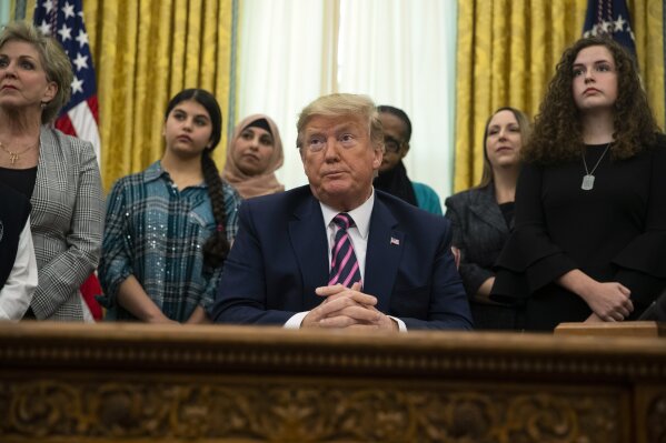 President Donald Trump listens to a question during an event on prayer in public schools, in the Oval Office of the White House, Thursday, Jan. 16, 2020, in Washington. (AP Photo/ Evan Vucci)
