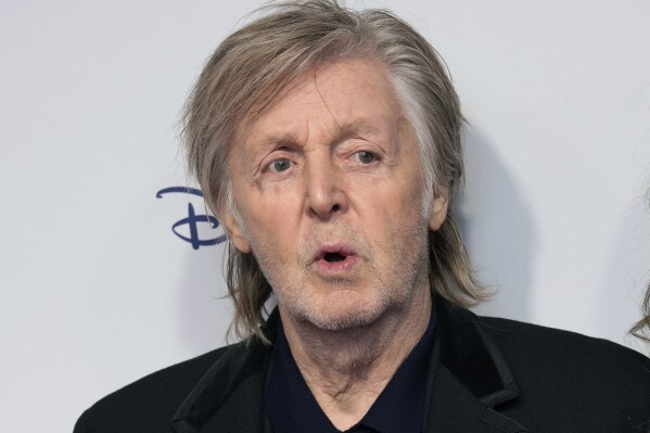 FILE - Paul McCartney and Nancy Shevell pose for photographers upon arrival for the premiere of the film 'If These Walls Could Sing' in London, Monday, Dec. 12, 2022. Artificial intelligence has been used to extract John Lennon's voice from an old demo to create “the last Beatles record,” Paul McCartney said Tuesday, June 13, 2023. McCartney, 80, told the BBC that the technology was used to separate the Beatles' voices from background sounds during the making of director Peter Jackson's 2021 documentary series, “The Beatles: Get Back." (Photo by Scott Garfitt/Invision/AP, File)