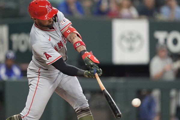 Los Angeles Angels' Kevin Pillar singles on a line drive to center field scoring Jo Adell and Zach Neto during the seventh inning of a baseball game against the Texas Rangers in Arlington, Texas, Sunday, May 19, 2024. (AP Photo/LM Otero)