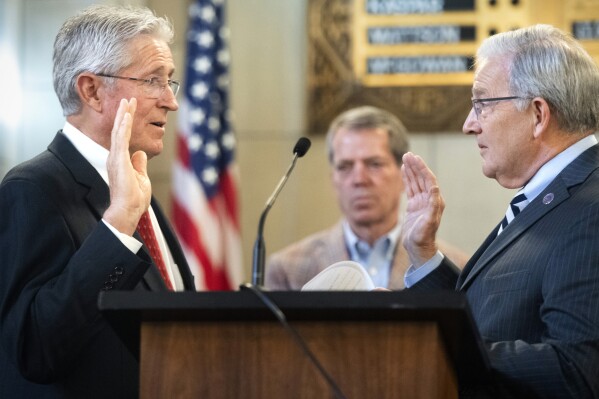 State Sen. Fred Meyer, left, of St. Paul, Neb., takes the oath of office administrated by Nebraska Secretary of State Robert Evnen, Wednesday, Nov. 15, 2023, in Lincoln, Neb. (Justin Wan/Lincoln Journal Star via AP)