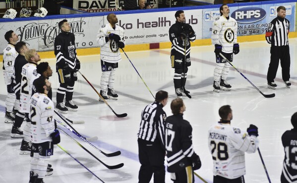 Players pay tribute before the Ice Hockey Adam Johnson memorial game between Nottingham Panthers and Manchester Storm at the Motorpoint Arena, Nottingham, England, Saturday, Nov. 18, 2023. The memorial game is held three weeks after Adam Johnson, 29, suffered a fatal cut to his neck during a game against Sheffield Steelers on Saturday, October 28. (AP Photo/Rui Vieira)