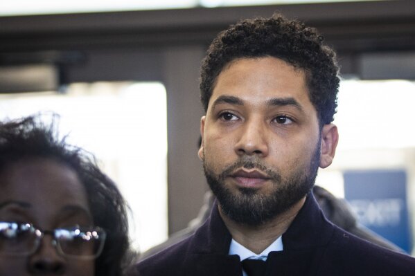 
              Actor Jussie Smollett listens as his attorney, Patricia Brown Holmes, speaks to reporters at the Leighton Criminal Courthouse after prosecutors dropped all charges against him, Tuesday morning, March 26, 2019. (Ashlee Rezin/Chicago Sun-Times via AP)
            