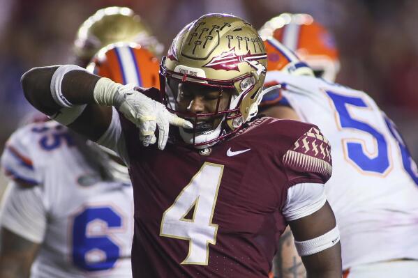 Florida State linebacker Kalen DeLoach (4) reacts after a tackle for a loss in the fourth quarter of the team's NCAA college football game against Florida Friday, Nov. 25, 2022, in Tallahassee, Fla. Florida State won 45-38. (AP Photo/Phil Sears)
