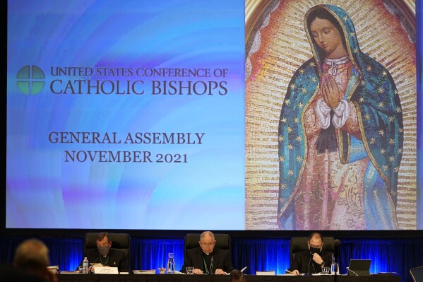 FILE - The United States Conference of Catholic Bishops holds its Fall General Assembly meeting in Baltimore, Nov. 16, 2021. The city of Baltimore has agreed to pay $275,000 toward the legal fees of a far-right Catholic media group to settle a lawsuit over the city's unsuccessful attempt to block a rally in 2021. (AP Photo/Julio Cortez, File)