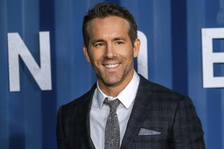 FILE - In this Tuesday, Dec. 10, 2019 file photo, Ryan Reynolds attends the premiere of Netflix's "6 Underground" at The Shed at Hudson Yards on in New York. Hollywood stars Ryan Reynolds and Rob McElhenney could be getting into the soccer business. Wrexham is a Welsh team which plays in the fifth tier of English soccer. It has revealed on Wednesday, Sept. 23, 2020 that Reynolds and McElhenney are the “two extremely well-known individuals” the club has previously said are interested in investing 2 million pounds ($2.5 million). (Photo by Charles Sykes/Invision/AP, file)