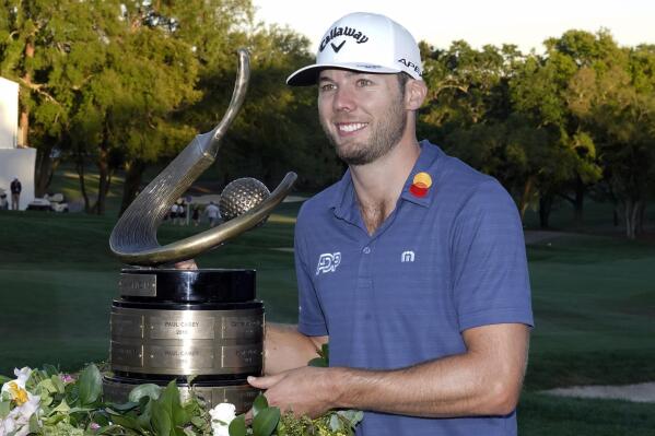Sam Burns poses with the trophy after winning the Valspar Championship golf tournament Sunday, March 20, 2022, at Innisbrook in Palm Harbor, Fla. (AP Photo/Chris O'Meara)