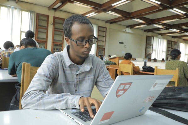 Yonas Nuguse, 21 years old, destined for Harvard University working on a computer at Wemezeker National Library in Addis Ababa, Ethiopia Friday, May 30, 2025. (AP Photo/Amanuel Birhane)