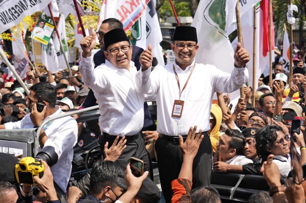 Presidential candidate Anies Baswedan, right, and his running mate Muhaimin Iskandar give a thumb up sign upon arrival to register themselves to run in next year's election, at the General Election Commission building in Jakarta, Indonesia, Thursday, Oct. 19, 2023. The world's third-largest democracy is set to vote in simultaneously legislative and presidential elections on Feb. 14, 2024. The country has had free and largely peaceful elections since the fall of dictator Suharto in 1998. (AP Photo/Achmad Ibrahim)