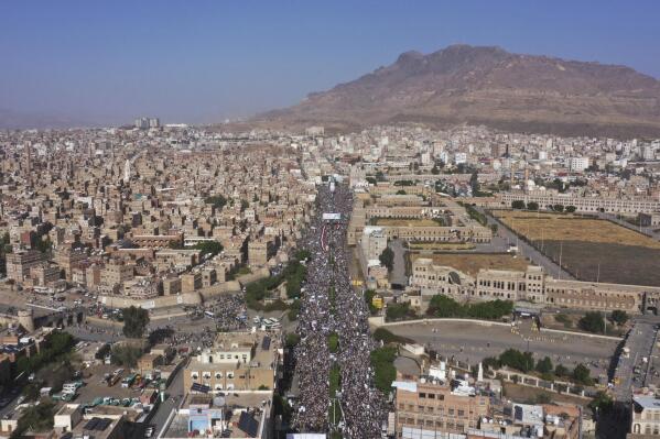 FILE - Houthi supporters attend a rally marking the seventh anniversary of the Saudi-led coalition's intervention in Yemen's war, in Sanaa, Yemen, March 26, 2022. Hans Grundberg, the U.N. special envoy for Yemen arrived Monday, April 11, 2022, in the capital of Sanaa for the first time since he assumed his post eight months ago for talks with the Houthi rebels, his office said. (AP Photo/Abdulsalam Sharhan, File)