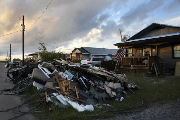 FILE - Debris and electrical wires are piled up in a front yard in Chauvin, La., on Sept. 27, 2021. $45 million funding bill to address soaring homeowner insurance rates in hurricane-battered Louisiana was up for debate Friday, Feb. 3, 2023 in the state's Senate. (AP Photo/Jessie Wardarski, File)