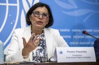Photini Pazartzis, Chairperson of the Committee, OHCHR, speaks about the Human Rights Committee presents findings on the political and civil rights in Hong Kong, Macao, Georgia, Ireland, Luxembourg and Uruguay, during a press conference at the European headquarters of the United Nations in Geneva, Switzerland, Wednesday, July 27, 2022. (Martial Trezzini/Keystone via AP)