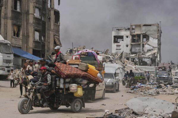 Displaced Palestinians fleeing Beit Lahia amid ongoing Israeli military operations in the Gaza Strip arrive in Jabalia, northern Gaza, on Sunday, May 18, 2025. (AP Photo/Jehad Alshrafi)