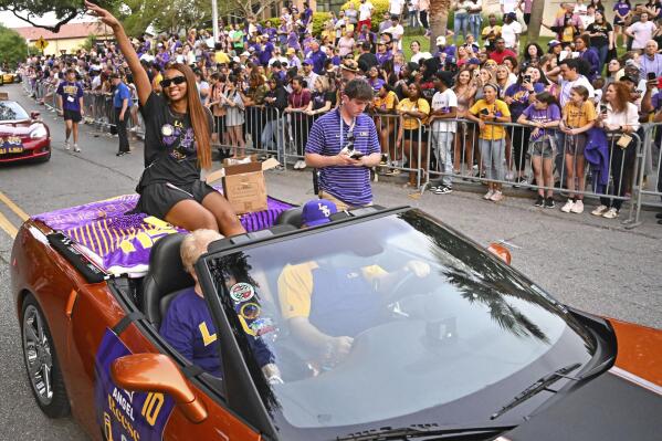 LSU forward Angel Reese waves to fans as the women's NCAA college national champion basketball team paraded across campus in Baton Rouge, La., Wednesday, April 5, 2023. (Hilary Scheinuk/The New Orleans Advocate via AP)