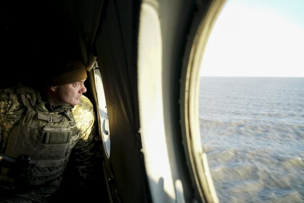 
              Serhiy Nayev, Ukrainian Lieutenant General, head of Joined Forces operation observes a sea shore through a helicopter's window during patrol near Urzuf, south coast of Azov sea, eastern Ukraine, Thursday, Nov. 29, 2018. Ukraine put its military forces on high combat alert and announced martial law this week after Russian border guards fired on and seized three Ukrainian ships in the Black Sea. (AP Photo/Evgeniy Maloletka)
            