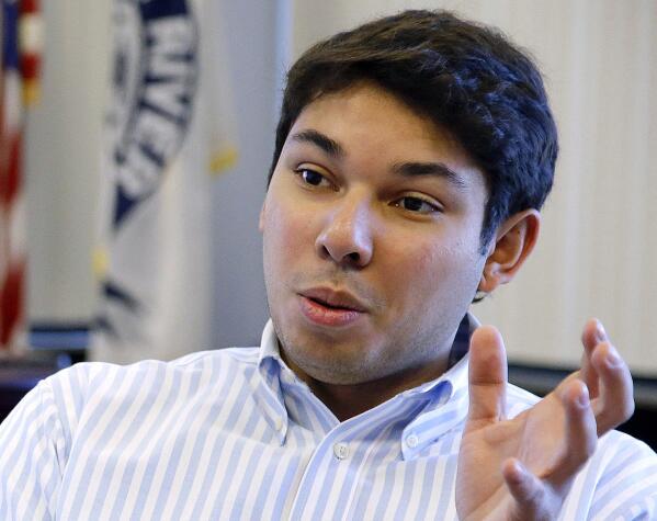 FILE - In this Jan. 6, 2016, file photo, Fall River Mayor Jasiel Correia talks in his city hall office in Fall River, Mass. Correia, first elected at the age of 23 by touting himself as a successful entrepreneur, was convicted Friday, May 14, 2021, of stealing money from investors in his start-up to bankroll his lavish lifestyle and soliciting bribes from marijuana vendors who wanted to operate in the struggling mill city. (  (AP Photo/Stephan Savoia, File)