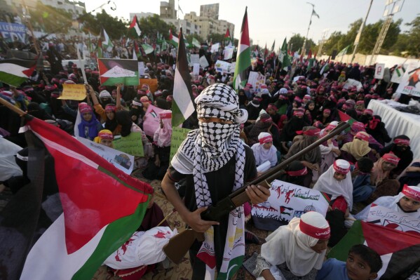 FILE - A supporter of Pakistan Markazi Muslim League holds an air gun as they take part in a rally against the Israeli airstrikes on Gaza to show solidarity with Palestinian people, in Karachi, Pakistan on Nov. 12, 2023. (AP Photo/Fareed Khan, file)