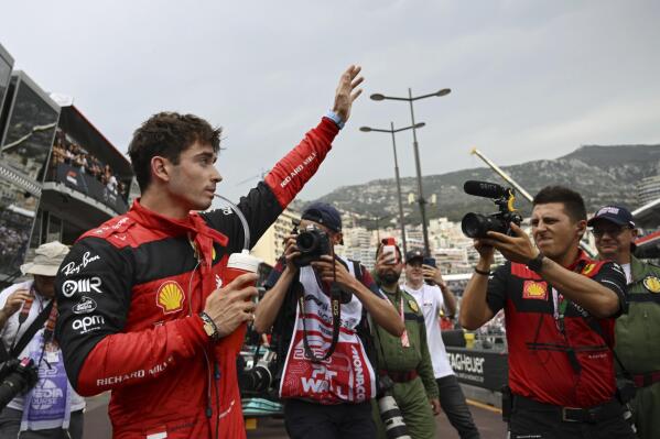Ferrari driver Charles Leclerc of Monaco celebrates after setting the pole position in the qualifying session at the Monaco racetrack, in Monaco, Saturday, May 28, 2022. The Formula one race will be held on Sunday. (Pool Photo/Christian Bruna/Via AP)