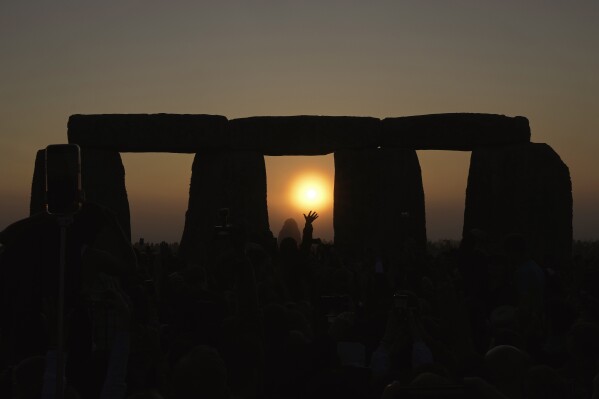 FILE - Revelers gather at the ancient stone circle Stonehenge to celebrate the Summer Solstice, the longest day of the year, near Salisbury, England, Wednesday, June 21, 2023. The United Nations’ cultural agency has rejected recommendations to place Stonehenge on the list of world heritage sites in danger over concerns that Britain’s plans to build a nearby highway tunnel threaten the landscape around the prehistoric monument. (ĢӰԺ Photo/Kin Cheung, File)