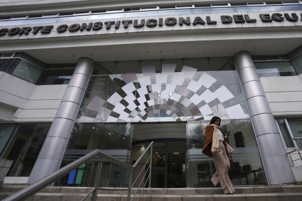 A woman exits the Constitutional Court building, in Quito, Ecuador, Wednesday, Feb. 7, 2024. Ecuador’s high court on Wednesday decriminalized euthanasia and ordered lawmakers and health officials to draft rules and regulations for the procedure. (AP Photo/Dolores Ochoa)