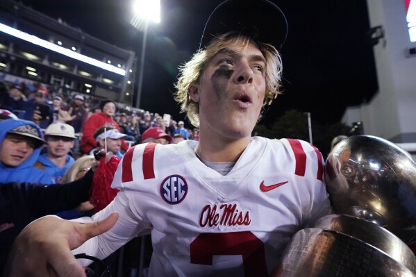 Mississippi quarterback Jaxson Dart (2) celebrates the team's win over Mississippi State in an NCAA college football game in Starkville, Miss., Thursday, Nov. 23, 2023. The winners receive the Golden Egg trophy. (AP Photo/Rogelio V. Solis)