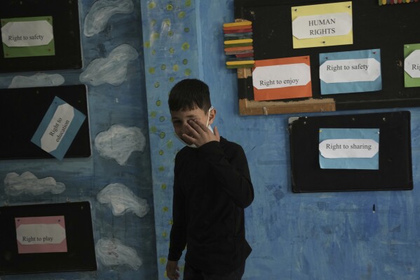 A boy rubs his eye after tear gas was fired by Israeli Police into the yard of the UNRWA Boys' School run by the U.N. agency for Palestinian refugees in the Shuafat Refugee Camp in east Jerusalem, Tuesday, April 29, 2025. (AP Photo/Maya Alleruzzo)