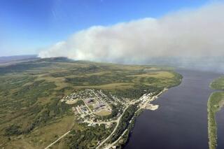 This June 10, 2022, aerial photo provided by the Bureau of Land Management Alaska Fire Service shows a tundra fire burning near the community of St. Mary's, Alaska. The largest documented wildfire burning through tundra in southwest Alaska was within miles St. Mary's and another nearby Alaska Native village, Pitkas Point, prompting officials Friday to urge residents to prepare for possible evacuation. (Ryan McPherson/Bureau of Land Management Alaska Fire Service via AP)