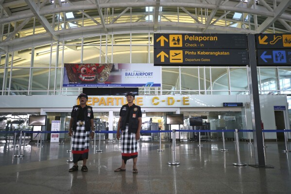 Balinese traditional guards called "pecalang" patrol the airport on Nyepi, or Day of Silence, in Bali, Indonesia on Monday, March 11, 2024. Airports closed for 24 hours, the internet was turned off and streets were empty as the predominantly Hindu island of Bali in Muslim-majority Indonesia marked its New Year with an annual Day of Silence, part of six days of extensive New Year rituals. (AP Photo/Firdia Lisnawati)