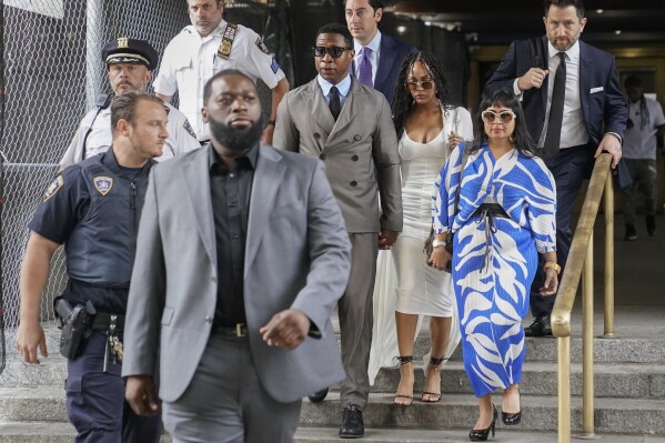 Jonathan Majors, center, Meagan Good, center right, and attorney Priya Chaudhry, right, leave court after a hearing on his domestic violence case, Thursday, Aug. 3, 2023, in New York. (AP Photo/John Minchillo)