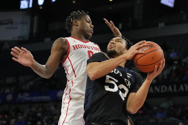 Butler guard Jair Bolden (52) drives against Houston guard Marcus Sasser in the first half during an NCAA college basketball game at the Maui Invitational in Las Vegas, Monday, Nov. 22, 2021. (AP Photo/Rick Scuteri)