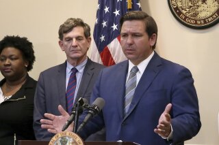 Florida Gov. Ron DeSantis speaks at a news conference about the recent coronavirus situation Wednesday March 11, 2020 in Tallahassee, Fla. For most people, the new coronavirus causes only mild or moderate symptoms. For some it can cause more severe illness. (AP Photo/Steve Cannon)