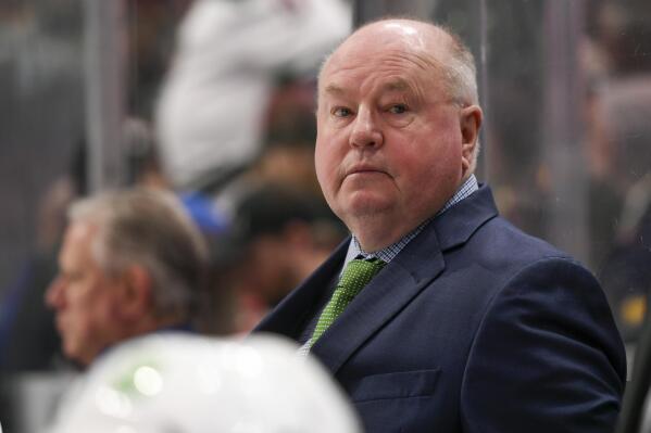 Vancouver Canucks coach Bruce Boudreau watches the team play against the Minnesota Wild during the third period of an NHL hockey game Thursday, April 21, 2022, in St. Paul, Minn. The Wild won 6-3. (AP Photo/Craig Lassig)