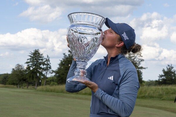Linnea Strom, of Sweden, kisses the trophy following the final round of the ShopRite LPGA Classic golf tournament, Sunday, June 9, 2024, in Galloway, N.J. (AP Photo/Chris Szagola)